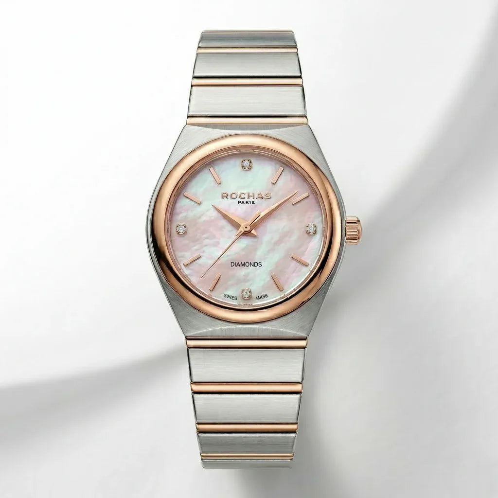 Silver and rose gold watch with a pink face on a light gray background
Salam Luxury