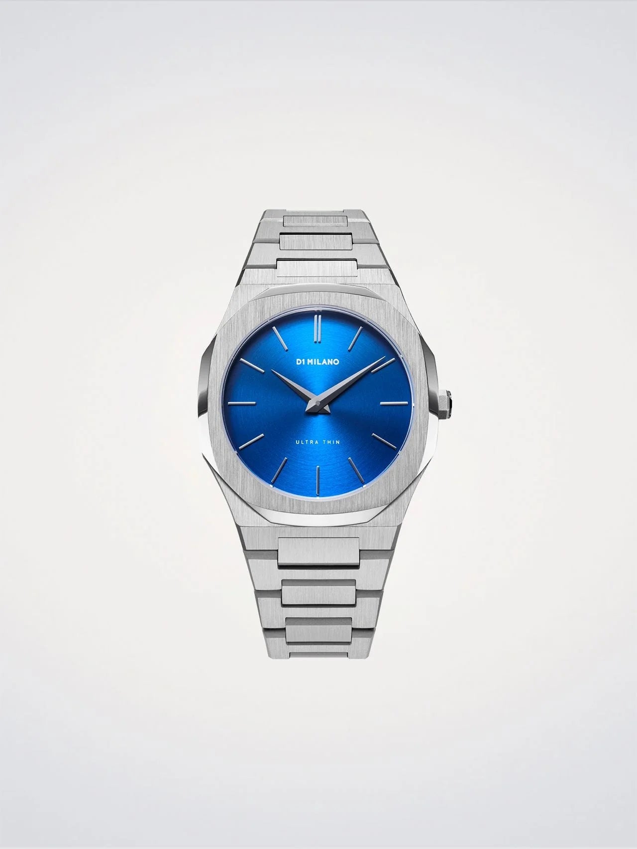 Silver watch with a blue face on a light gray background
Salam Luxury