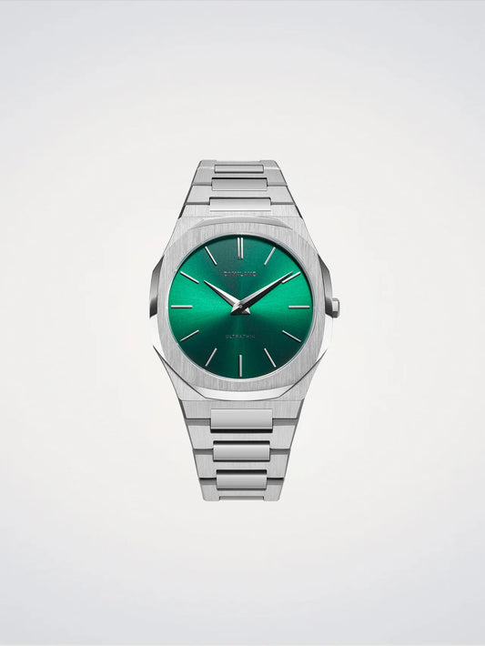 Silver watch with a green face on a light gray background
Salam Luxury