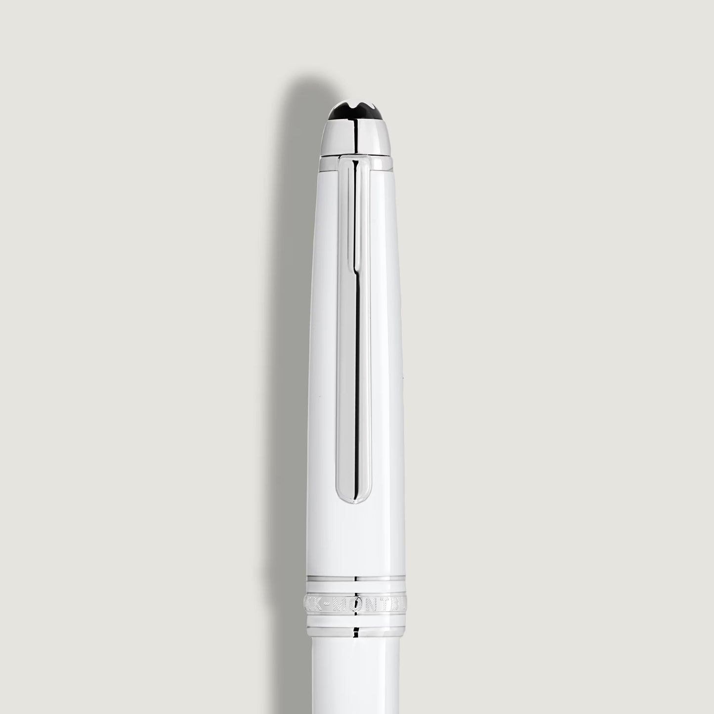Close-up of the white resin cap featuring the iconic Montblanc emblem and platinum clip, showcased by Salam Luxury.