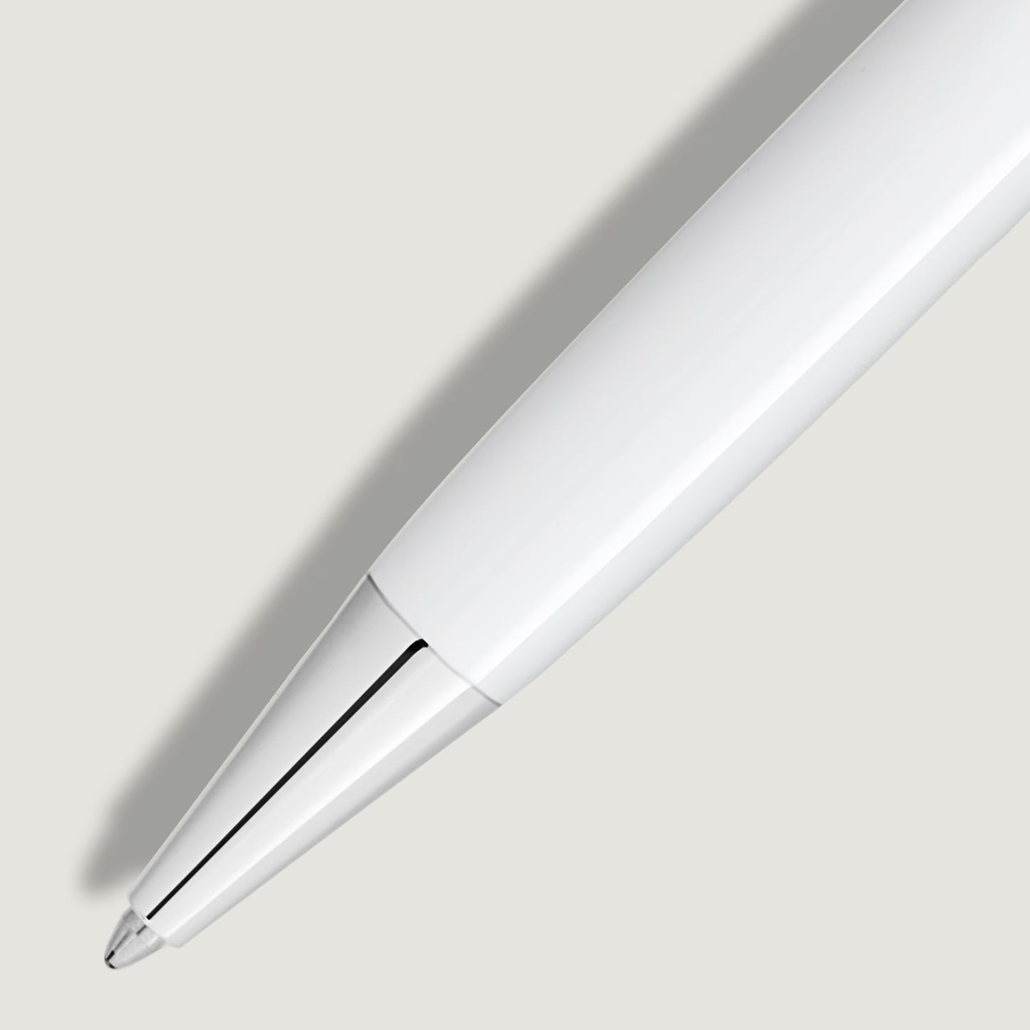 Detailed close-up of the polished platinum-plated tip and sleek white barrel of the luxury pen from Salam Luxury.