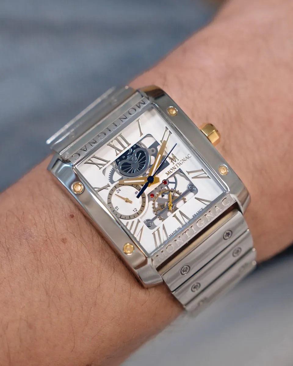 Silver | Salam Luxury men's silver skeleton watch with white dial and gold details, styled on a wrist.