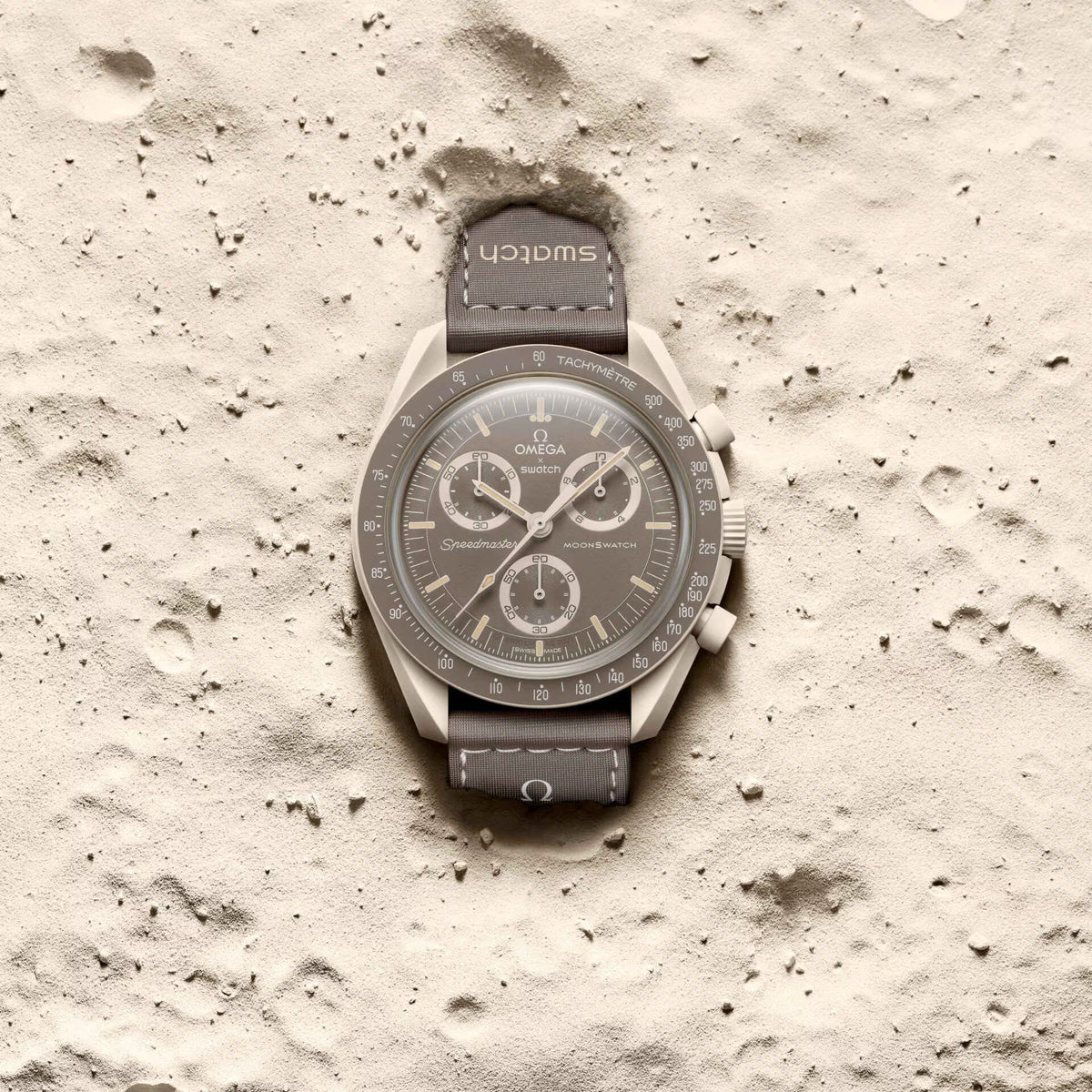 Desert | Omega x Swatch Mission on Earth watch on a beige textured surface - SALAM LUXURY