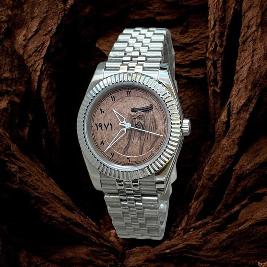 Silver watch with a wooden face on a textured brown background
Salam Luxury