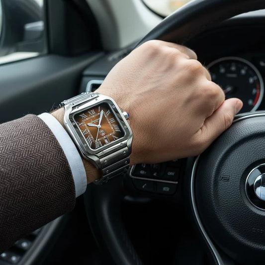 Hand wearing a silver wristwatch with a brown face on a car 
dashboard.
Salam Luxury UAE