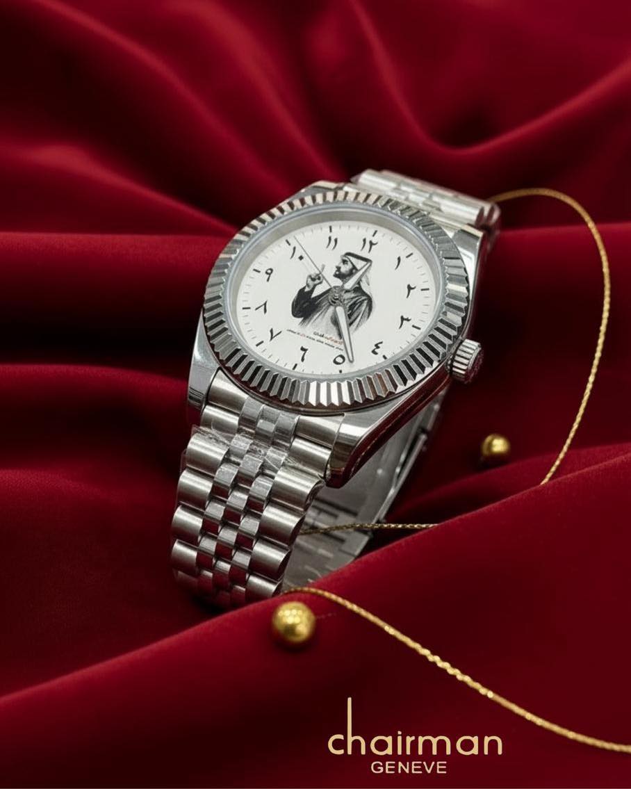 Arabic - Silver watch with a unique face design on a red fabric background, featuring the brand 'Chairman Geneve'. Salam luxury 
