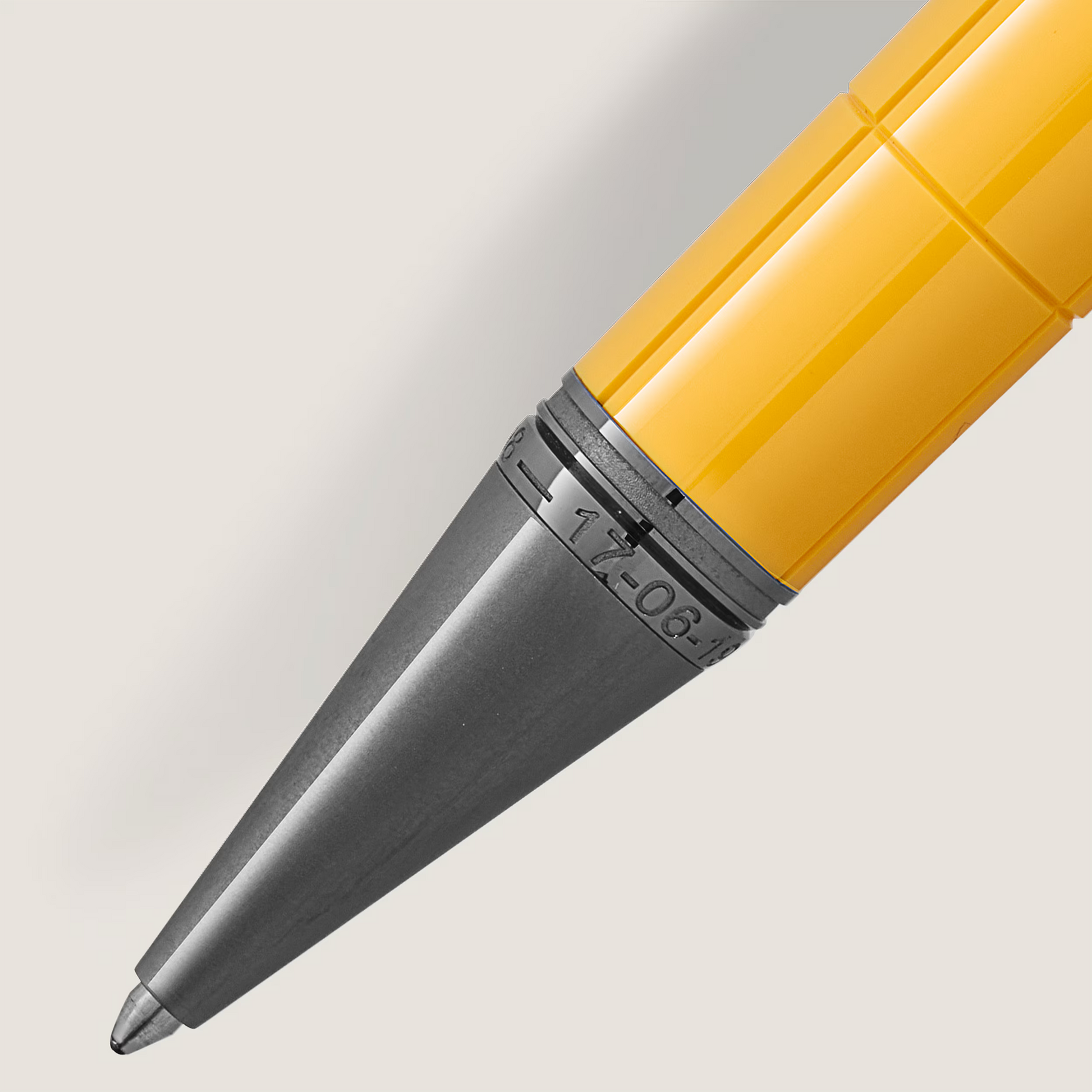 Extreme close-up of the matte grey ruthenium-coated tip with date engraving and vibrant Giallo Modena yellow barrel of the Montblanc Enzo Ferrari ballpoint pen from Salam Luxury.