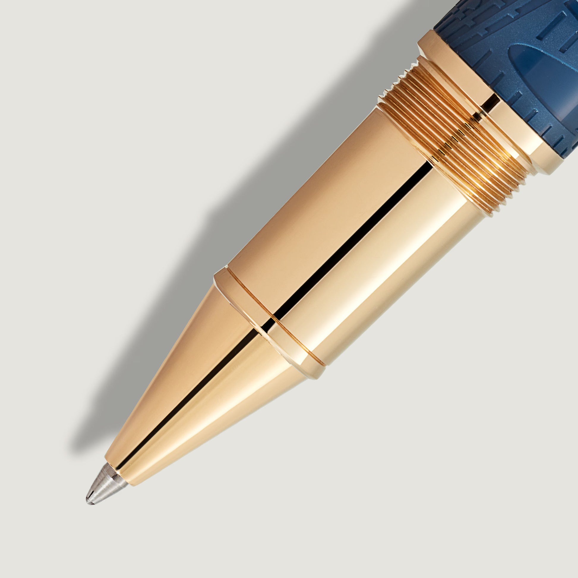 Detailed view of the champagne gold-coated front section and blue textured barrel of the Homage to Queen Victoria rollerball pen from Salam Luxury.