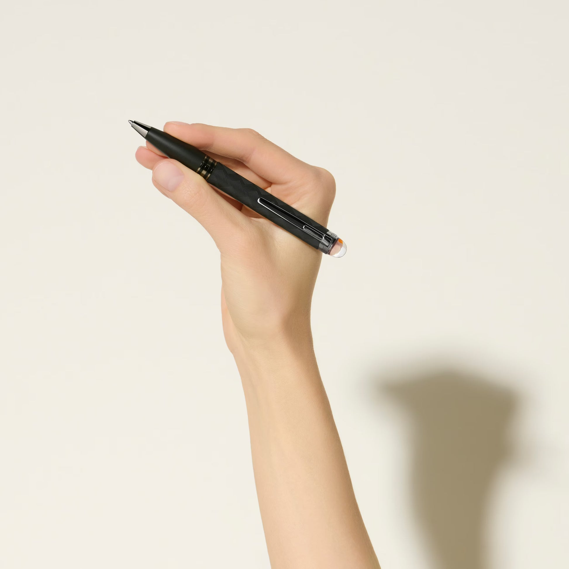 A person holding the StarWalker Extreme luxury black ballpoint pen in hand, demonstrating its premium grip and classic writing style - Salam Luxury.