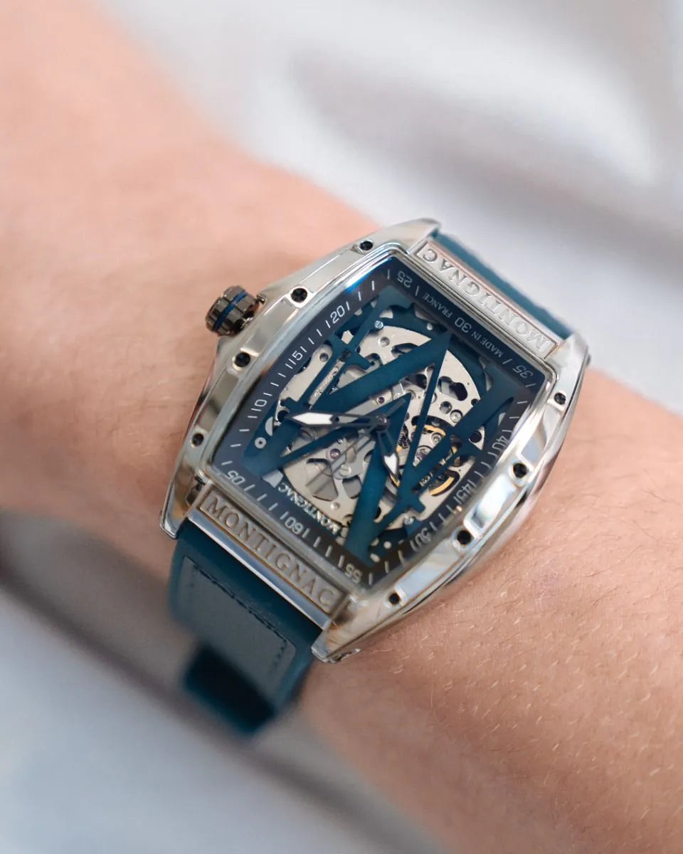 Luxury watch with blue strap and intricate design on a wrist against a neutral background
Salam Luxury