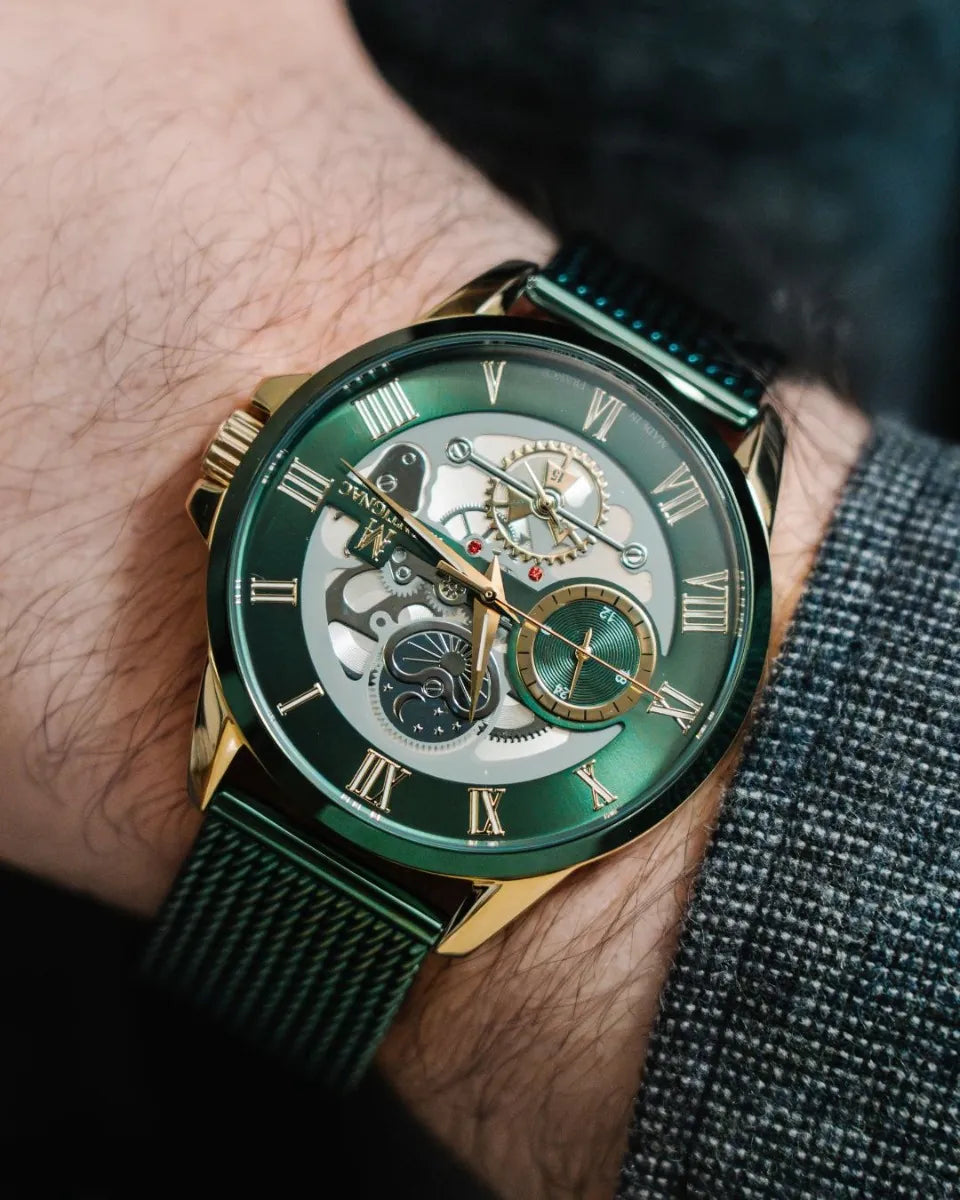 Green | wristwatch with gold accents on a person's wrist