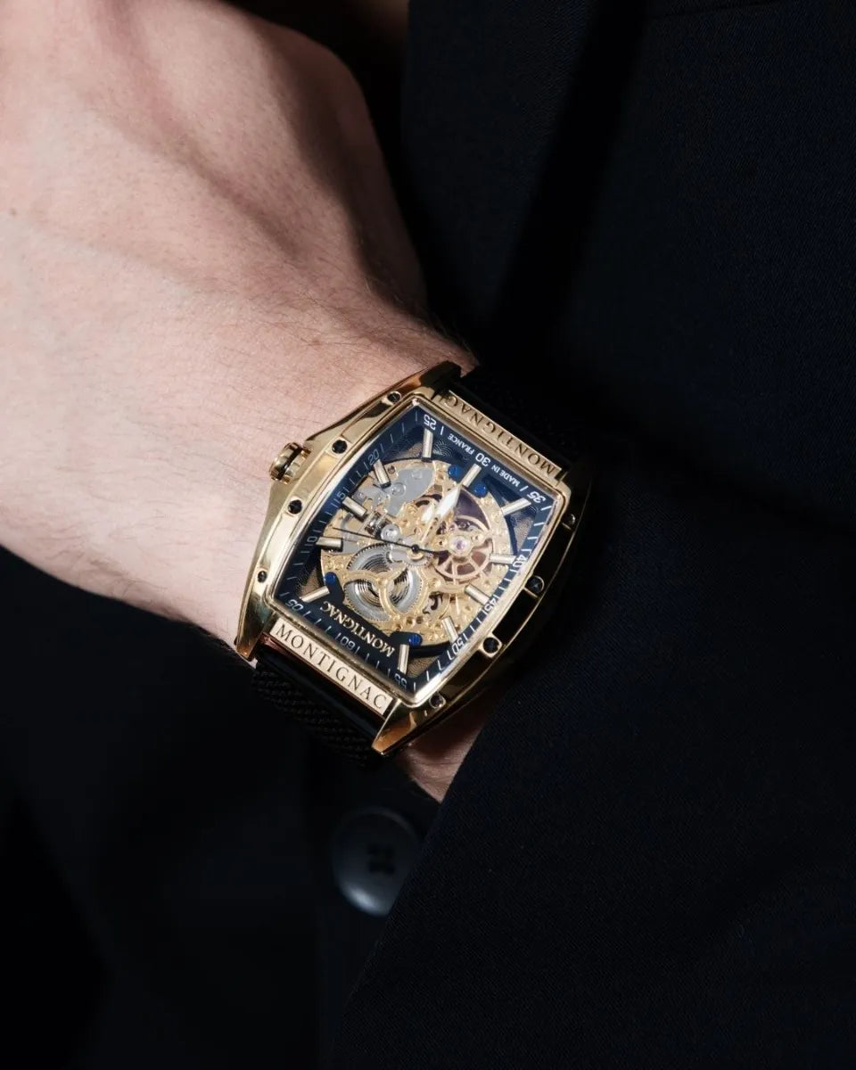 Luxury watch with intricate design on a person's wrist against a dark background