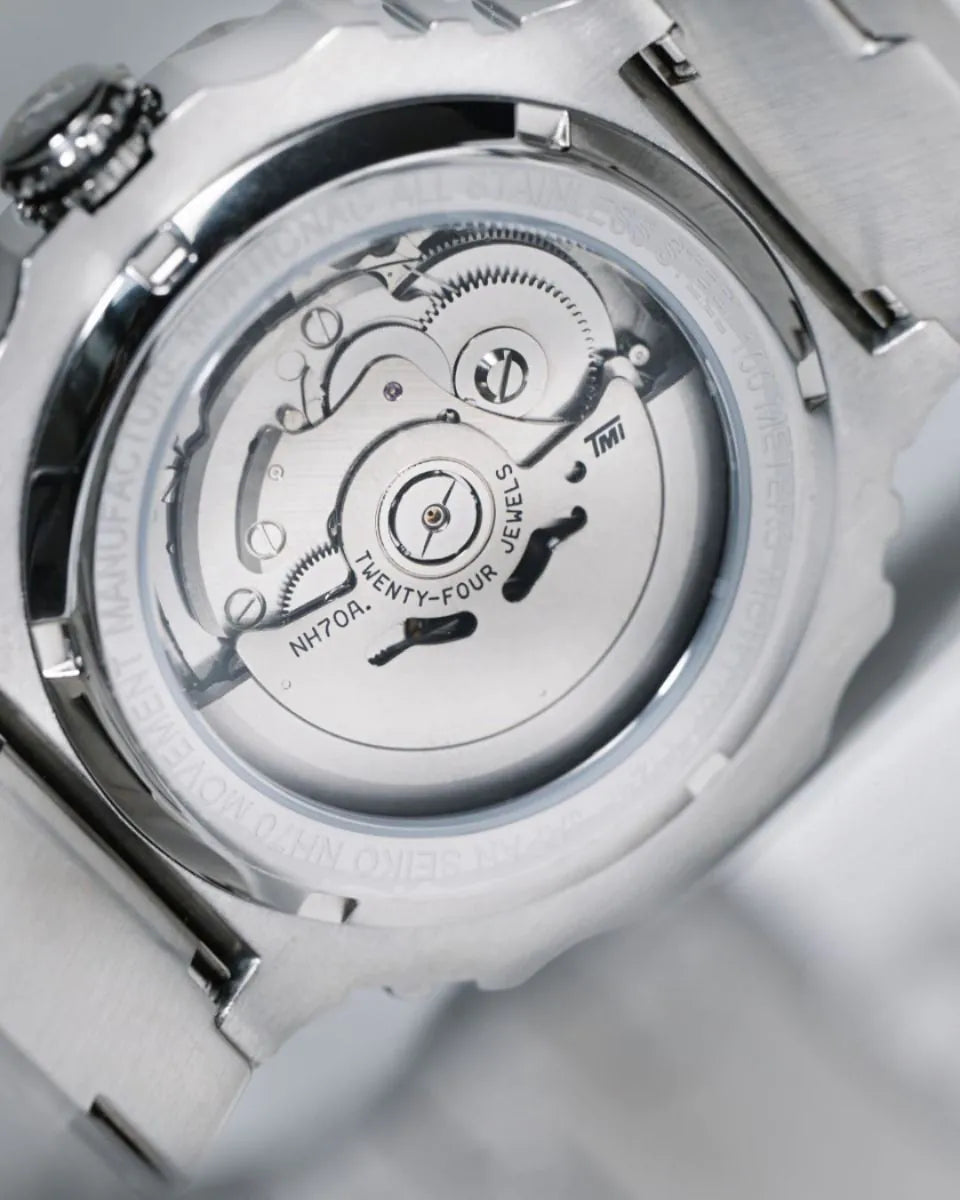 Close-up of a watch mechanism with visible branding on a light gray background
