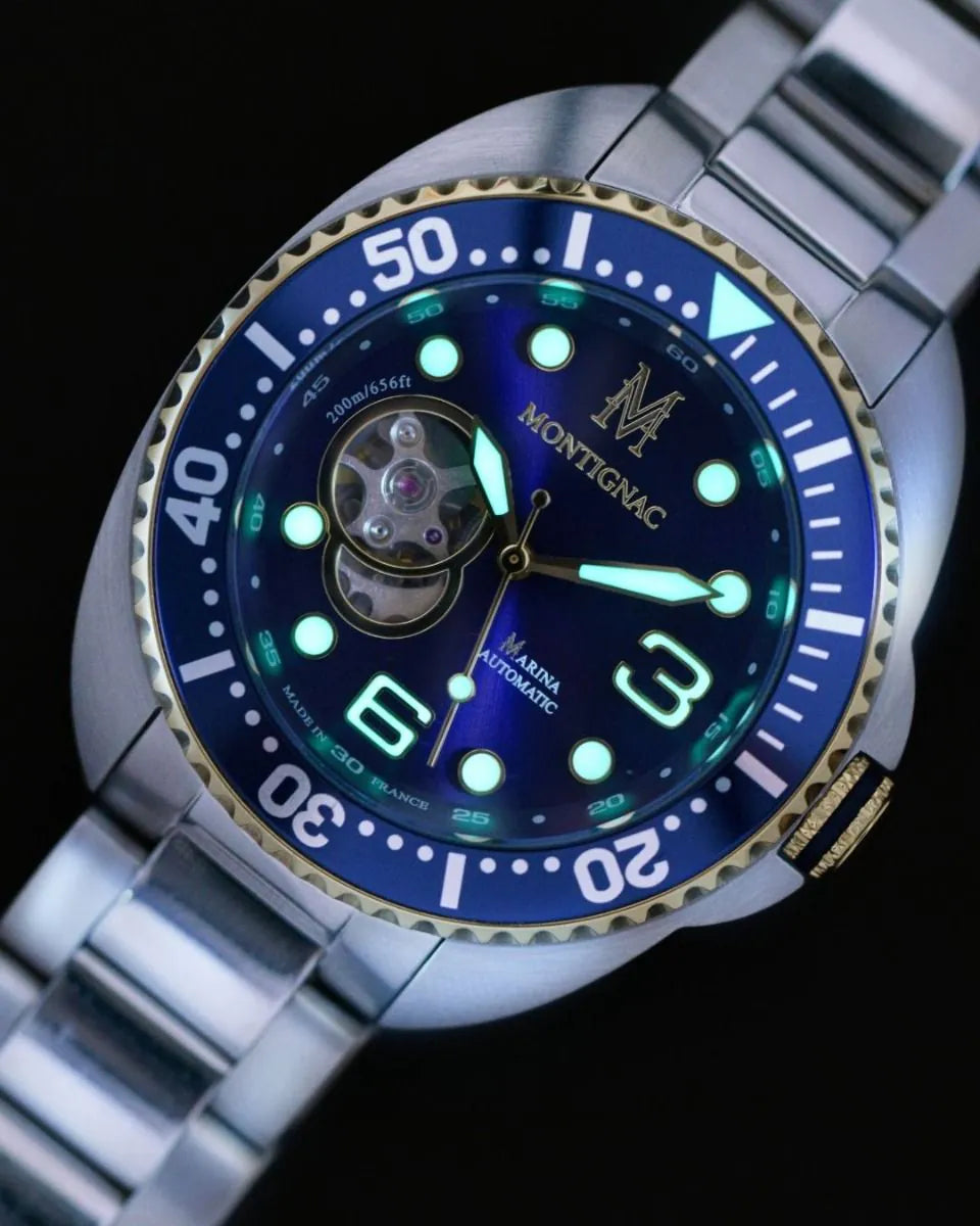 Montignac watch with blue face and silver band on a black background