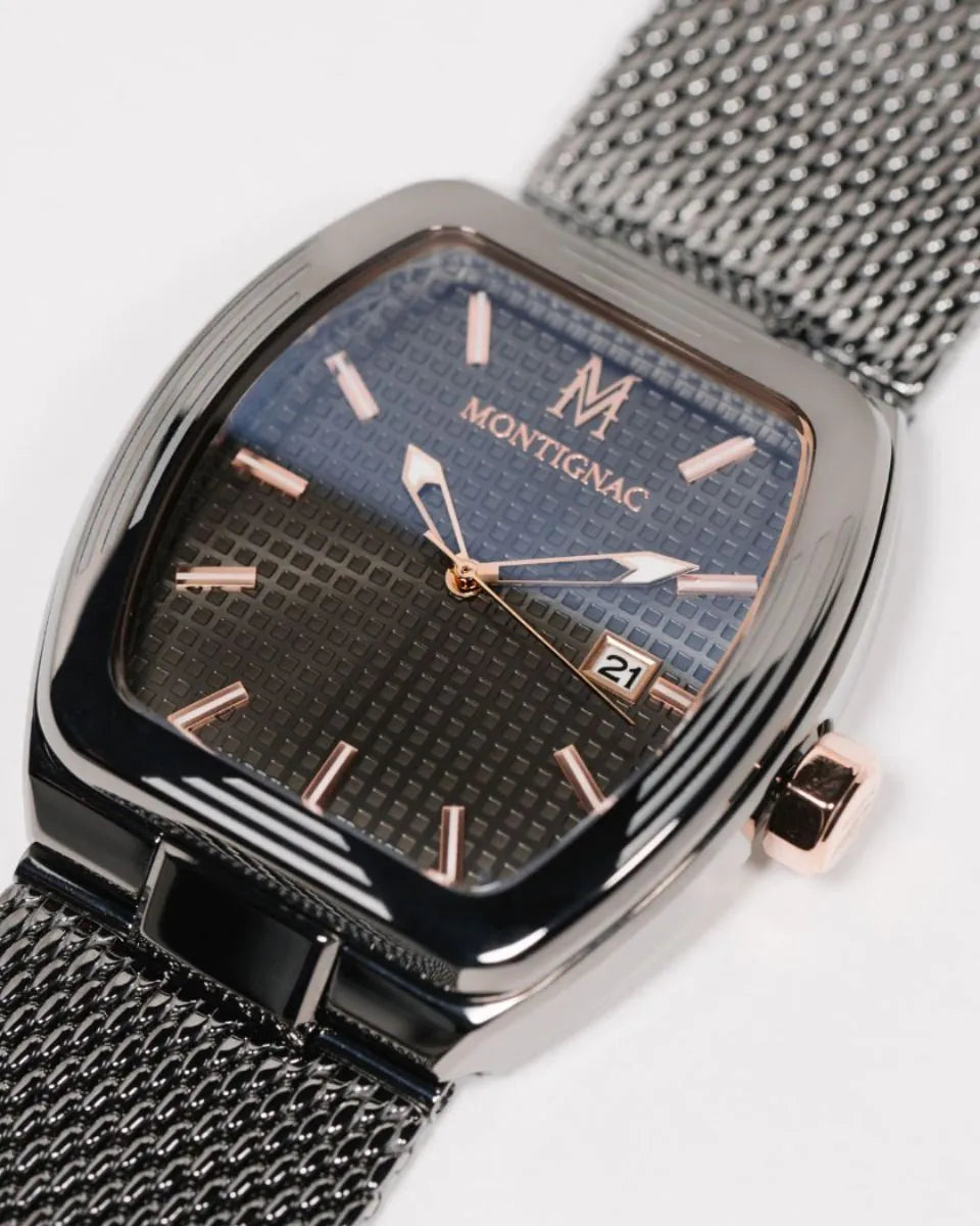 Montignac watch with black mesh strap and blue face on a white background