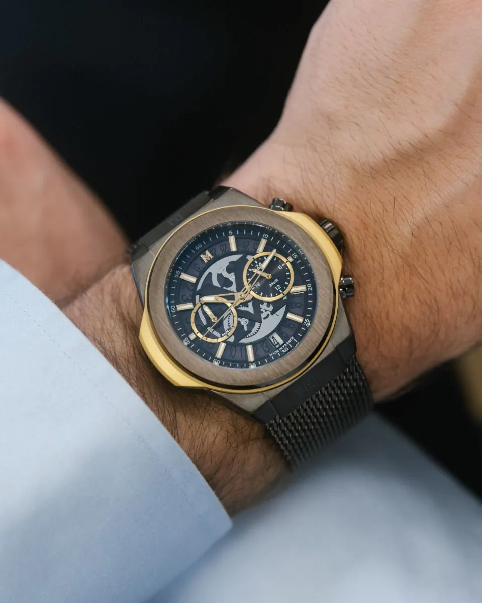 Brown | Luxury watch with blue face and gold accents on a wrist.
Salam Luxury UAE