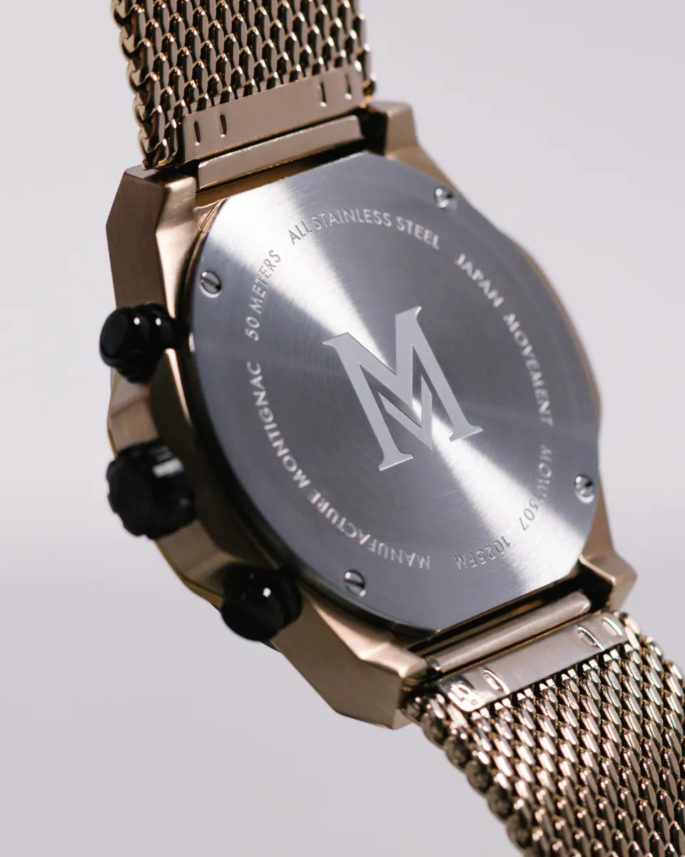 Champagne | Gold watch with a visible brand logo on a light gray 
background
Salam Luxury