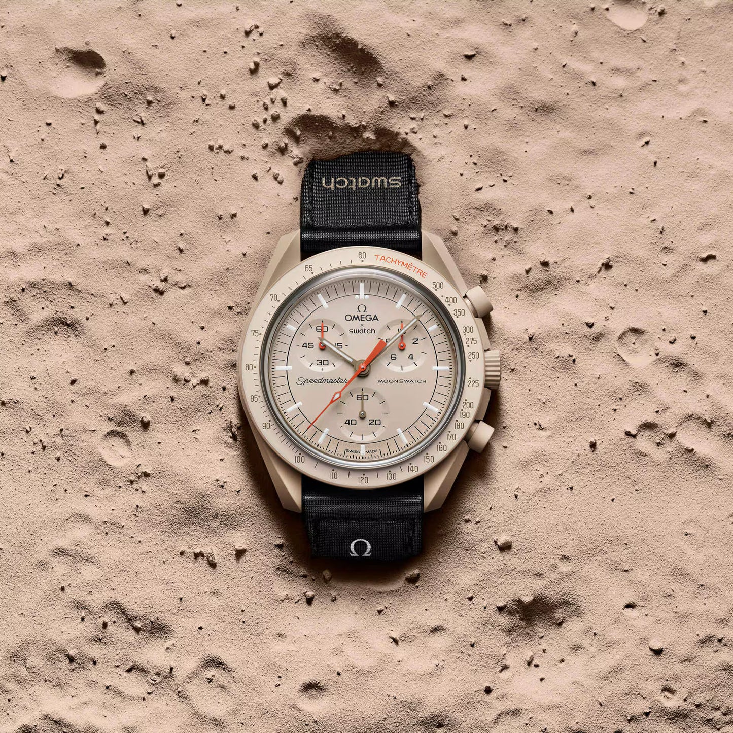 Omega x Swatch MoonSwatch Mission to Jupiter watch on sandy surface - Salam Luxury