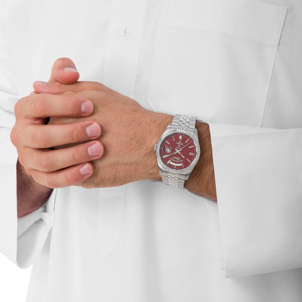 Maroon | Person wearing a silver watch with a red face on a white background
Salam Luxury UAE