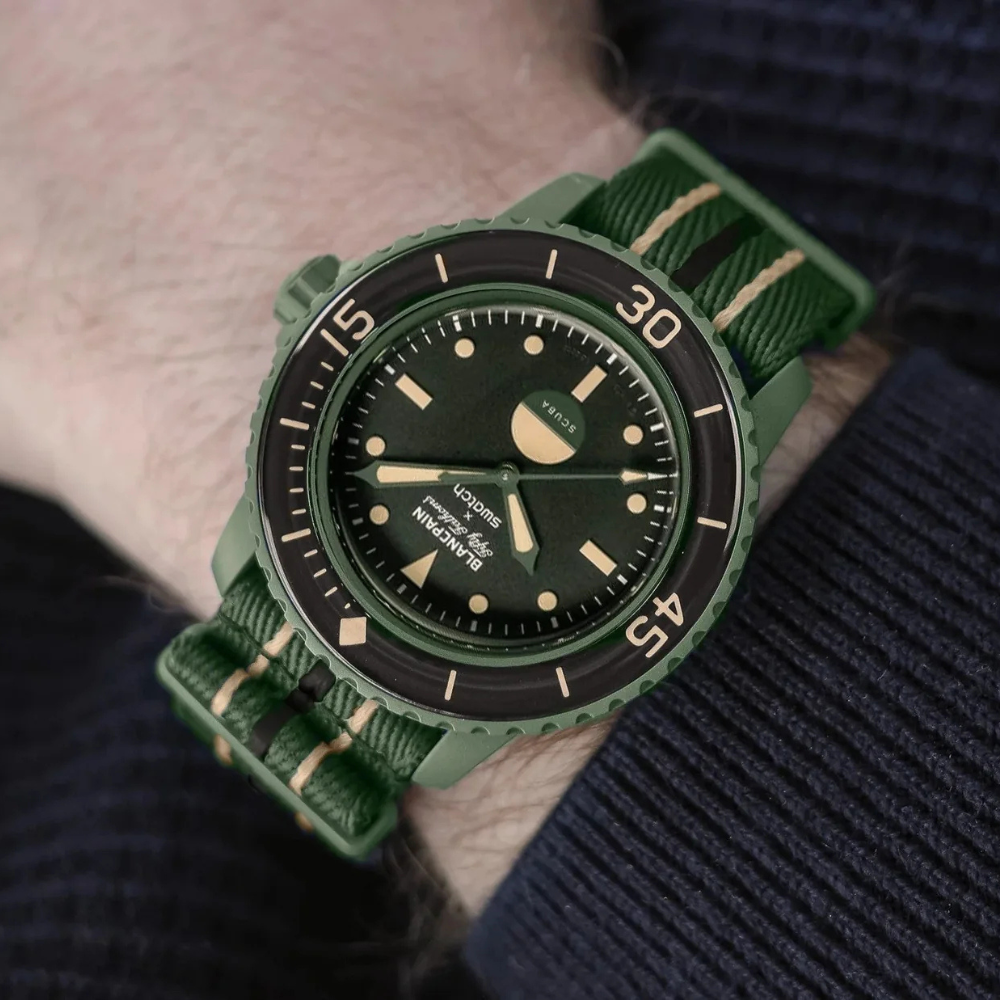 Salam Luxury wrist shot showcasing the green Blancpain x Swatch SO35G100 luxury timepiece worn.